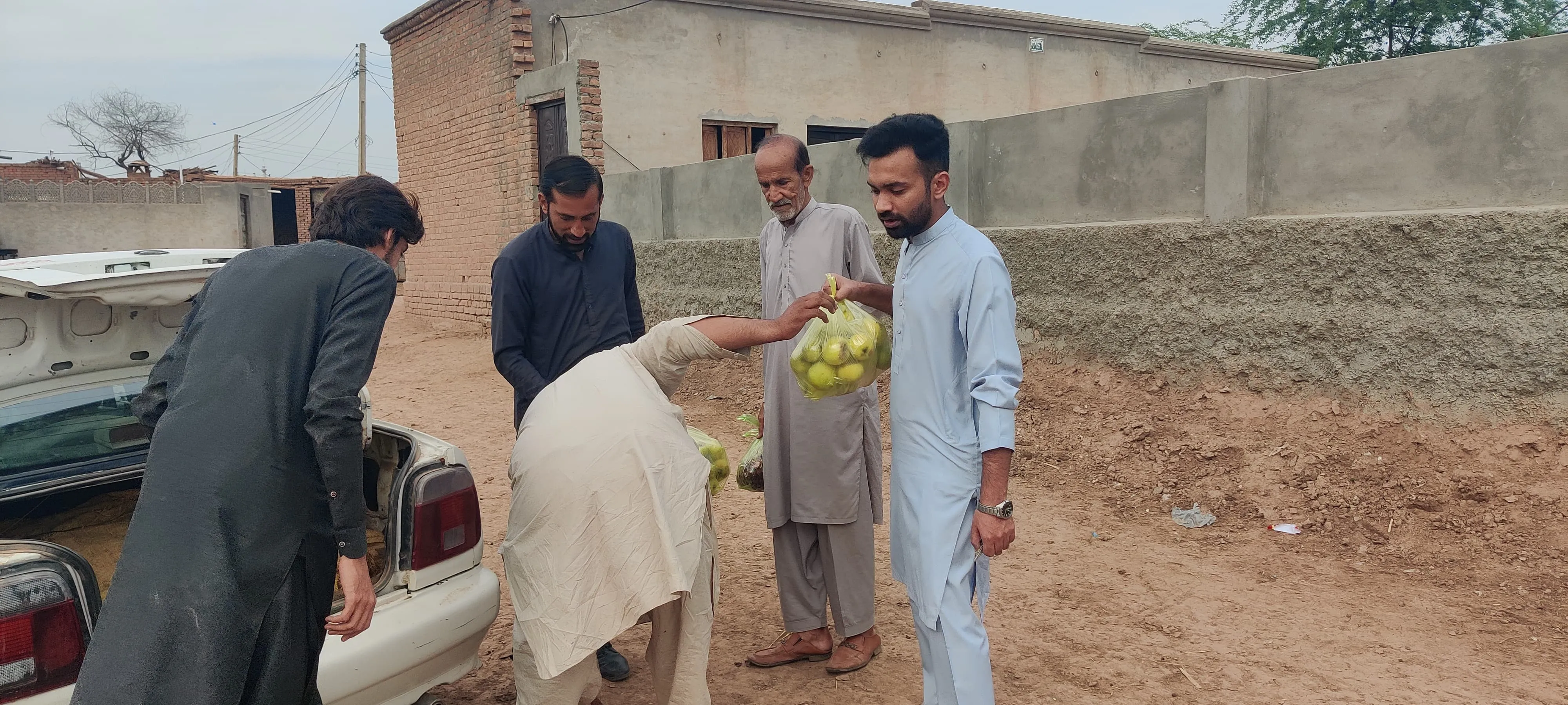Volunteers handing ration to beneficiary family